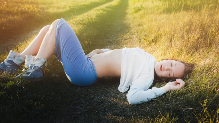 a woman lying in the grass